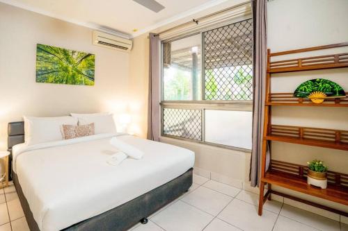a bedroom with a white bed and a window at Zenhouse Worker Accom-Trailer - Storage - Pets in Nightcliff