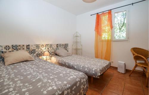 a bedroom with two beds and a window and a chair at 2 Bedroom Lovely Home In Piscia Rossa in Afa