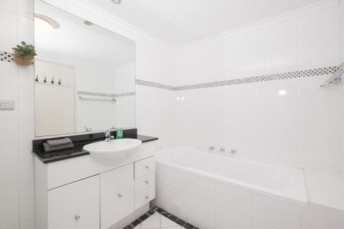 a white bathroom with a sink and a tub at Fantastic 3 Bds apartment Darling Harbour & Fish Market & Chinatown & Casino & Central in Sydney