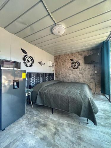 a bedroom with a bed and a television in it at Apple House cerca de la playa in Barra de Navidad