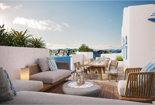 a patio with chairs and a table on a balcony at Wyndham Garden Sonasea Van Don in Cái Rồng