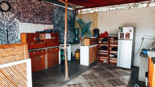 a kitchen with wooden cabinets and a refrigerator at Complejo Don Pascual in San Pedro La Laguna