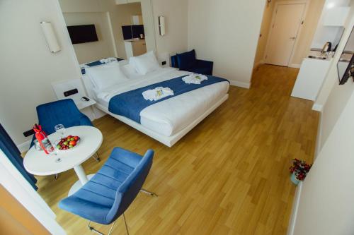 巴統的住宿－Orbi Hotel City Batumi Sea View，卧室配有一张床和一张桌子及椅子