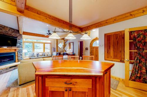 a kitchen and living room with a large wooden island at Kootenai Haus in Sandpoint