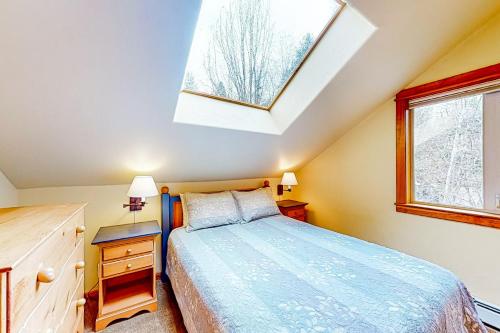 a bedroom with a bed and a skylight at Kootenai Haus in Sandpoint