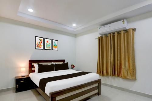 a bedroom with a bed and a window at Collection O Madhapur near Cyber Tower in Hyderabad