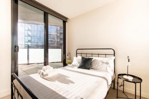 - une chambre avec un lit et une grande fenêtre dans l'établissement Fit For A Queen with Free Parking-Pool-Gym, à Melbourne