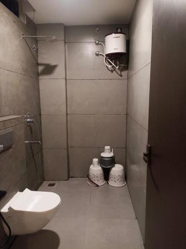 a small bathroom with a toilet and a sink at Prakhyat in Maheshwar