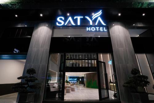 a sign for a santoku hotel in front of a building at Satya Da Nang Hotel Han Market in Da Nang