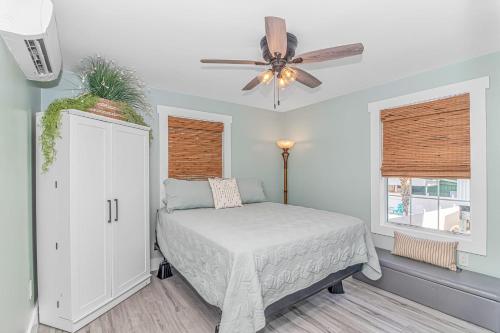 a bedroom with a bed and a ceiling fan at Beachside Retreat - Garden City - Murrells Inlet in Myrtle Beach