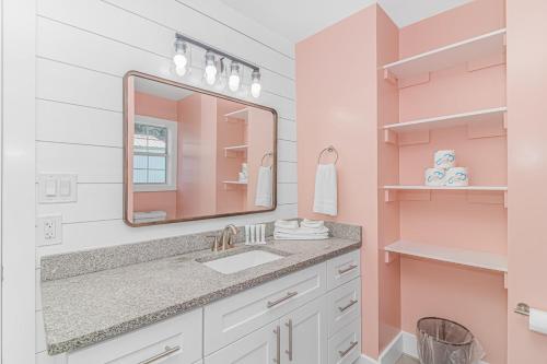 a bathroom with a sink and a mirror at Beachside Retreat - Garden City - Murrells Inlet in Myrtle Beach