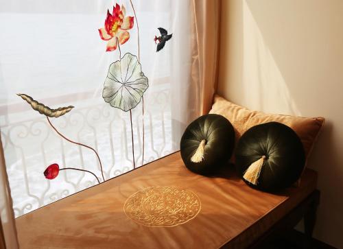 two pillows sitting on a wooden table with a window at Indochine Cruise Lan Ha Bay in Ha Long