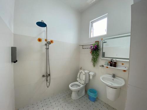 a bathroom with a shower and a toilet and a sink at Lucky hotel in Ho Chi Minh City