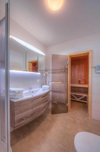 a large bathroom with a tub and a sink at Gartendeck 532 in Rechlin