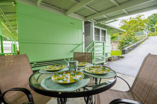 a glass table with plates of food on it at Hale Leilani - Hilo 3BR cold AC in Hilo