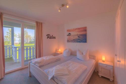 a bedroom with a bed and a large window at Mitteldeck 523 in Rechlin