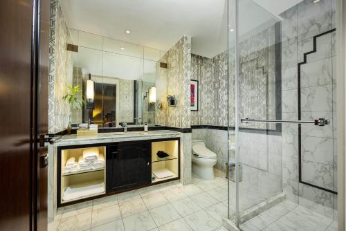 a bathroom with a shower and a sink and a toilet at Jinjiang Metropolo Hotel Classiq,Shanghai Bund Circle in Shanghai