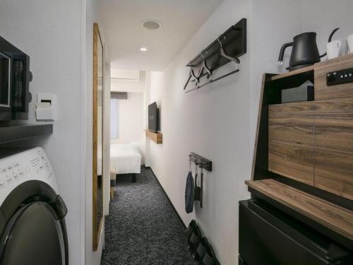 a laundry room with a washer and dryer at Tokyu Stay Nishi Shinjuku in Tokyo