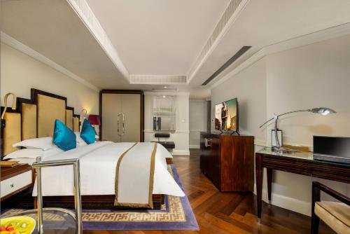 a bedroom with a large bed and a desk at Jinjiang Metropolo Hotel Classiq,Shanghai Bund Circle in Shanghai