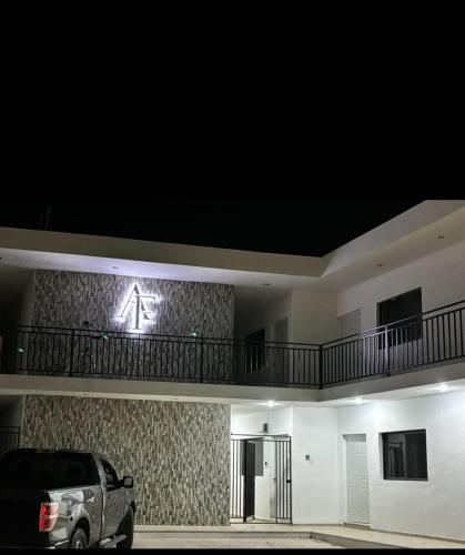 a car parked in front of a building at night at Departamento AF 1 in Tizimín