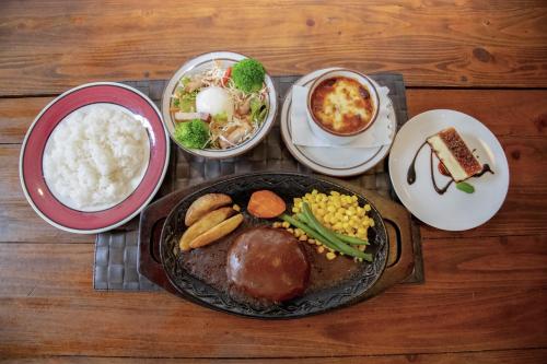 a table with a plate of food and bowls of food at El Patio Ranch in Aso