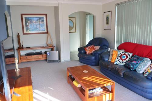 a living room with two couches and a coffee table at Dolphinview in Denhams Beach