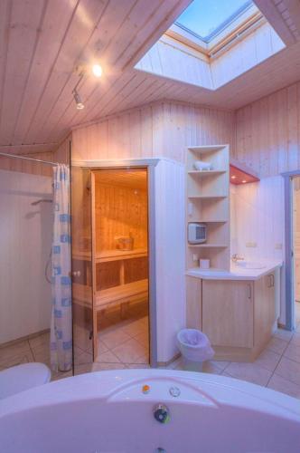 a bathroom with a tub and a sink and a toilet at Seeschwalbe 69A in Rechlin