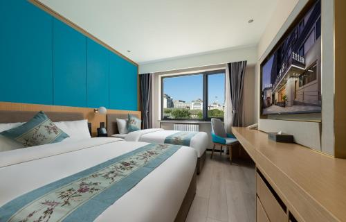 a hotel room with two beds and a large window at Beijing Jingfang Building - Near Tiananmen Square and the Forbidden City,Newly opened hotel,Heating is provided during winter in Beijing