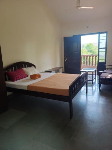 a bedroom with a large bed in a room at Ashirwad Residency in Agonda
