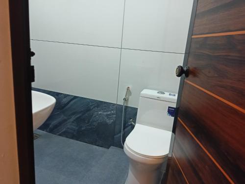 a bathroom with a toilet and a sink at Eden Homestays in Wayanad