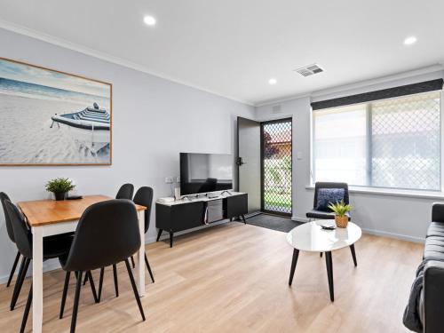 a living room with a couch and a table at Hectorville Luxe Haven Suite in Campbelltown