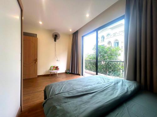 a bedroom with a bed and a large window at Homestay CX 8 -129 in Hòa Bình