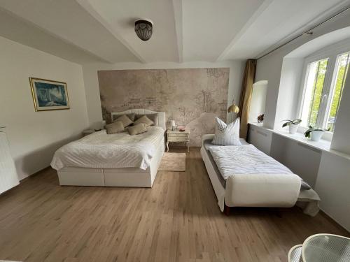a bedroom with two beds and a wall mural at Ferienwohnung Kaiserblick in Bad Ems