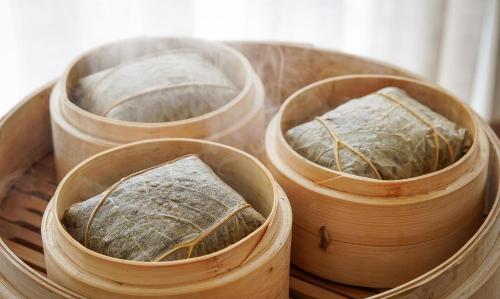 three wooden barrels with bread in them on a table at Windsleep International Apartment Hotel-Free delivery to the venue of the Canton Fair&Cantonese Breakfast in Guangzhou