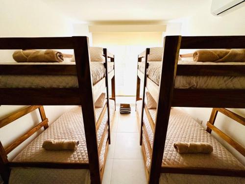 a group of three bunk beds in a room at Agradable estancia en Monterrico in Monterrico