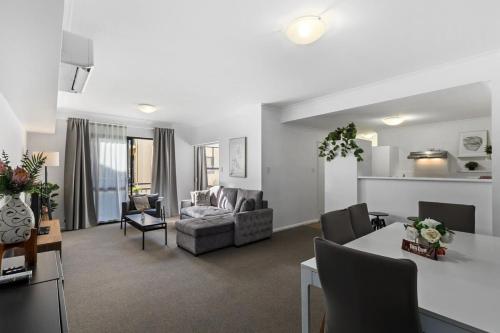 a living room with a couch and a table at Family Apartment close to Perth City in Perth
