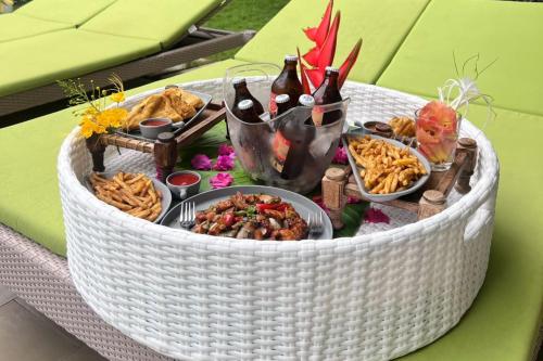 a white wicker table with food and drinks on it at ELIVAAS 6 BHK Farmhouse with Pvt Pool & Garden - Enchantia in Bhundsi