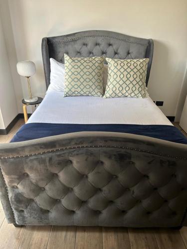 a large bed with a metal frame in a bedroom at Venecia 1BR Zona 10 Luxury Suite - Pool, Jacuzzi, Gym & View in Guatemala