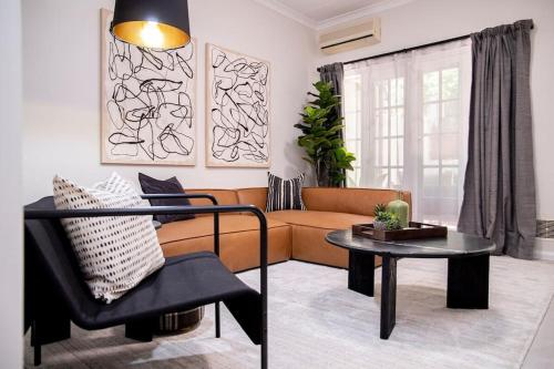 a living room with a couch and a table at Stunning Northbridge Townhouse W Off St Parking in Perth