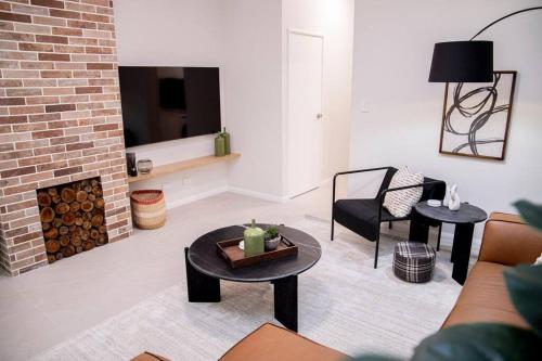 a living room with a couch and a fireplace at Stunning Northbridge Townhouse W Off St Parking in Perth