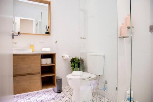 a bathroom with a toilet and a sink and a shower at Stunning Northbridge Townhouse W Off St Parking in Perth