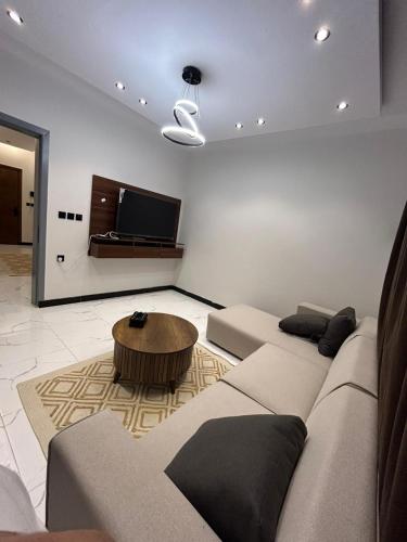 a living room with a couch and a coffee table at سويت في حي مشرفه في شارع فلسطين in Jeddah