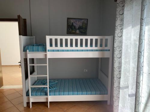 a white bunk bed in a room at Ilirian Hotel in Lezhë