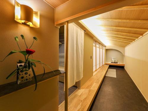 a hallway of a house with a plant on a shelf at Hotel New Wakasa in Nara