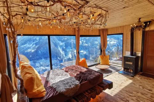 a bedroom with a bed in front of a large window at Eco House Merisi in Merisi