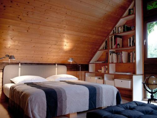 a bedroom with a bed and a book shelf at Bergwiesen - Studio House 
