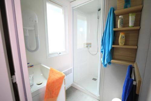 y baño con ducha y lavamanos. en Camping International & Spa 4*, en Hyères
