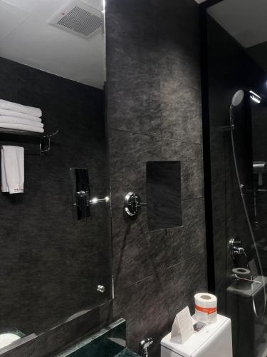 a bathroom with a shower and a toilet at Marvelous Hotel in Tabuk