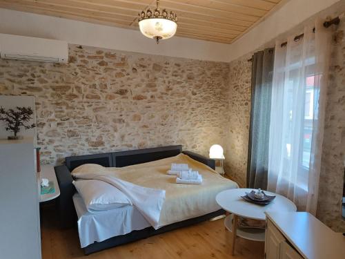a bedroom with a large bed and a table at Casa Lehovo in Lechovo