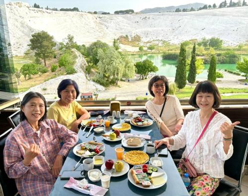 a group of women sitting at a table eating food at Pamukkale Sahin Boutique Hotel in Pamukkale